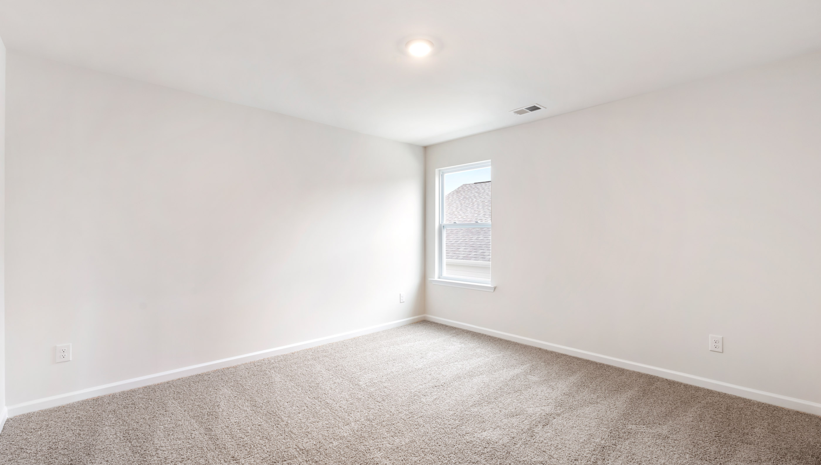 Bedroom with carpet and windows.