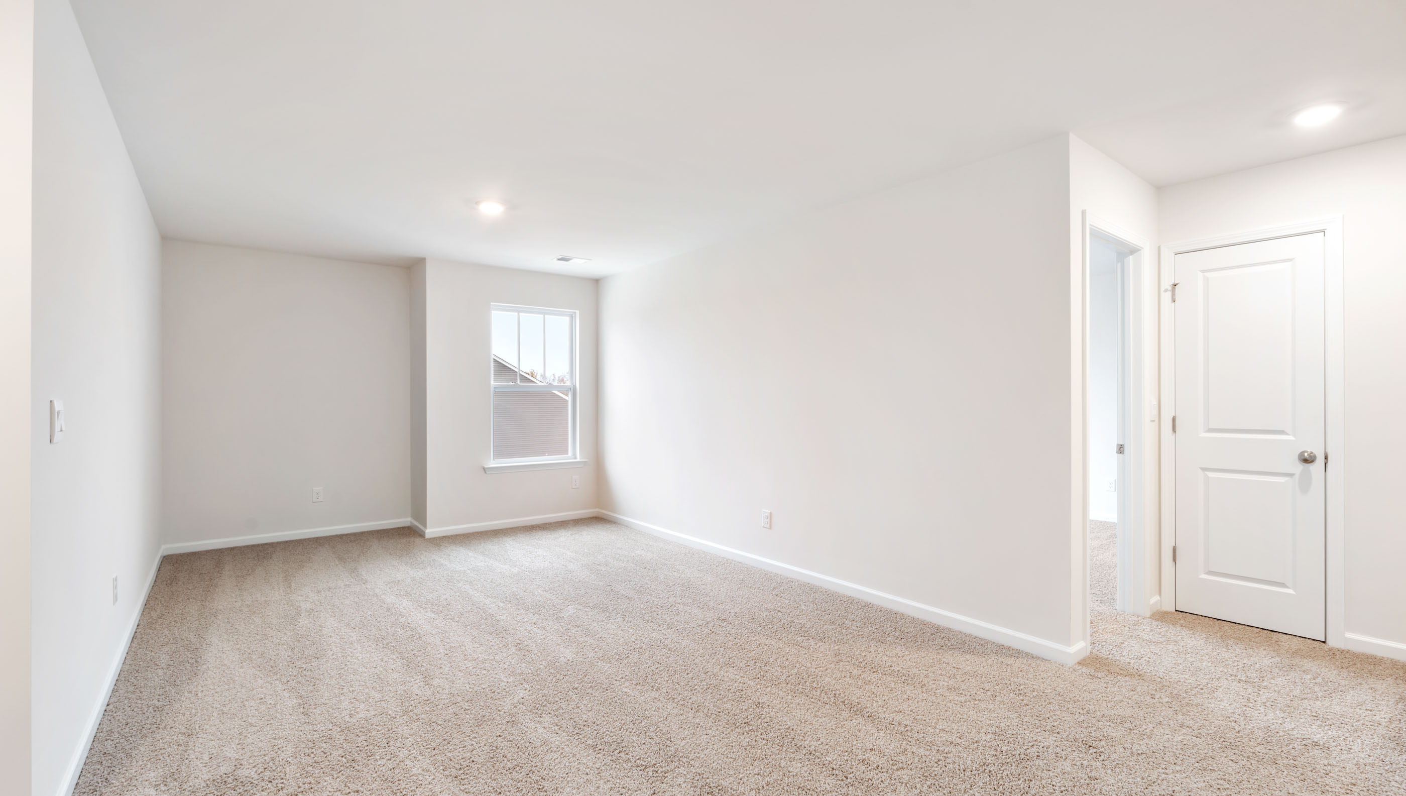 Loft area with carpet and windows.