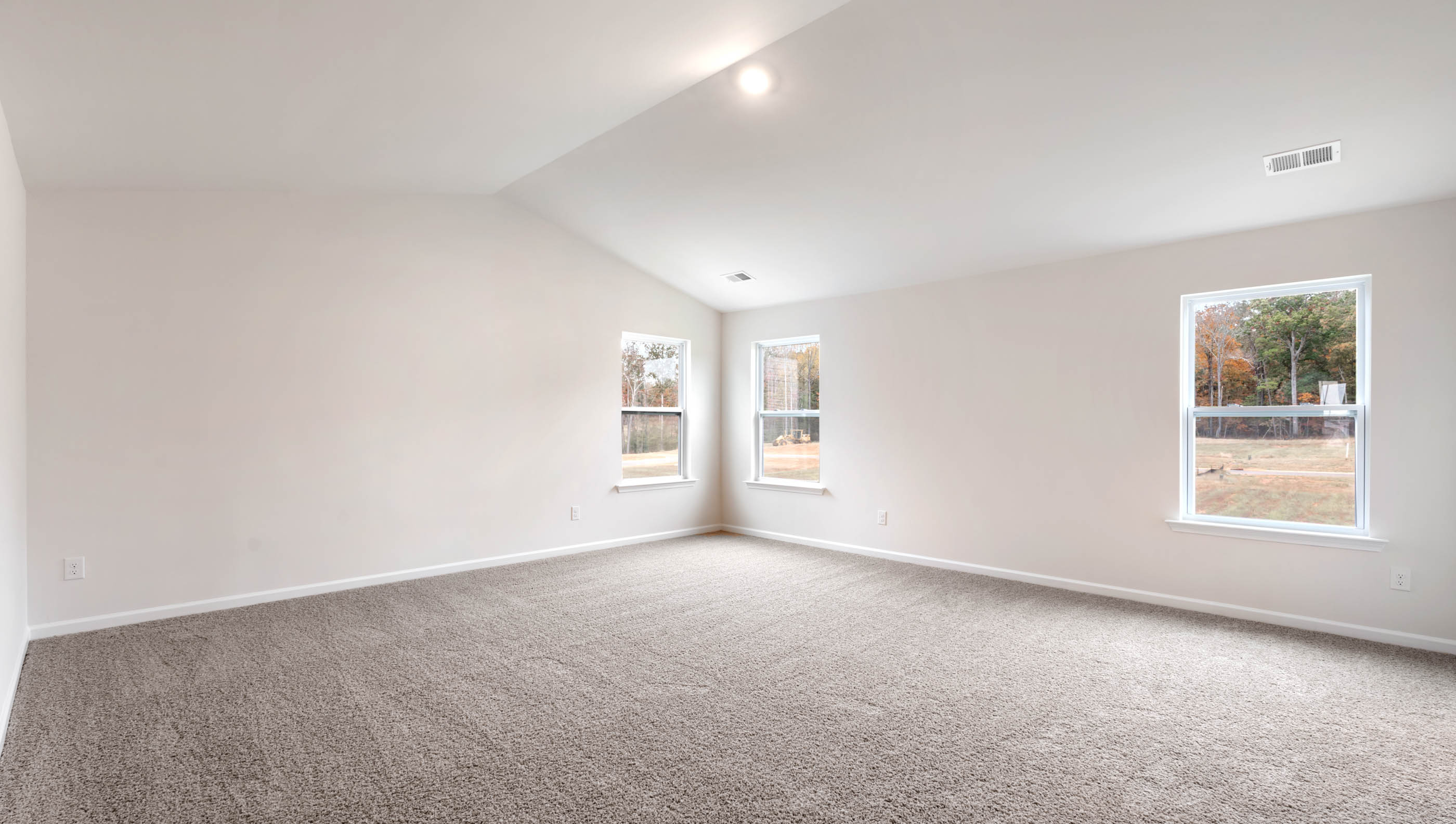 Bedroom with carpet and windows.