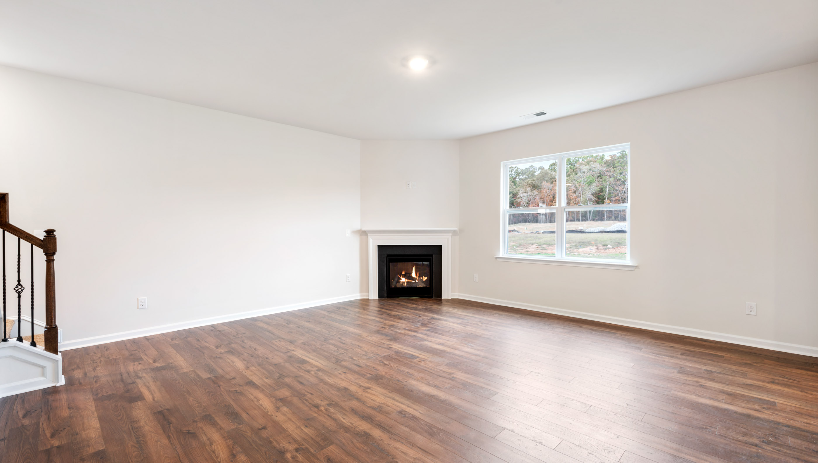 Family room with fireplace and windows.