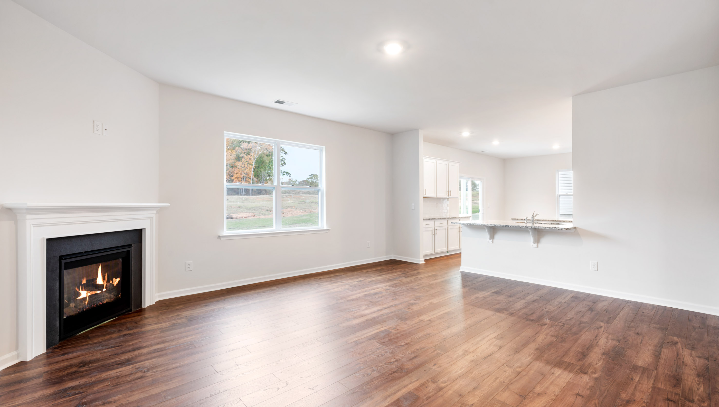 Family room with fireplace and windows.
