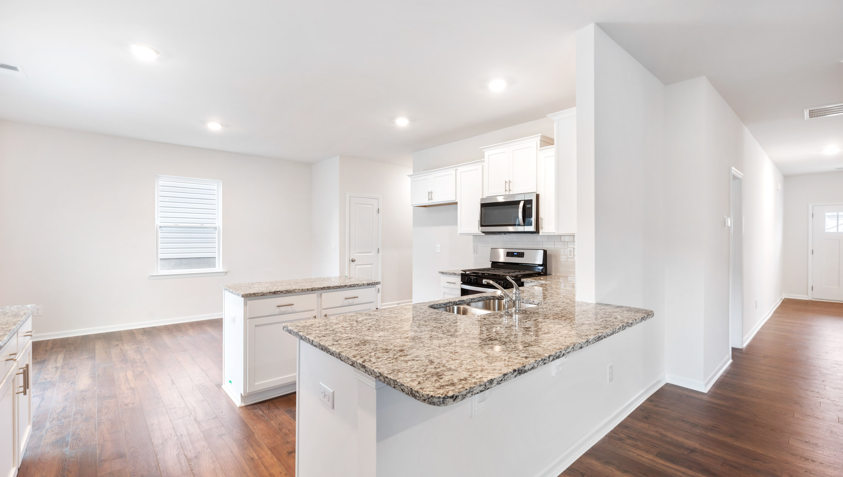 Kitchen with island and granite countertops.