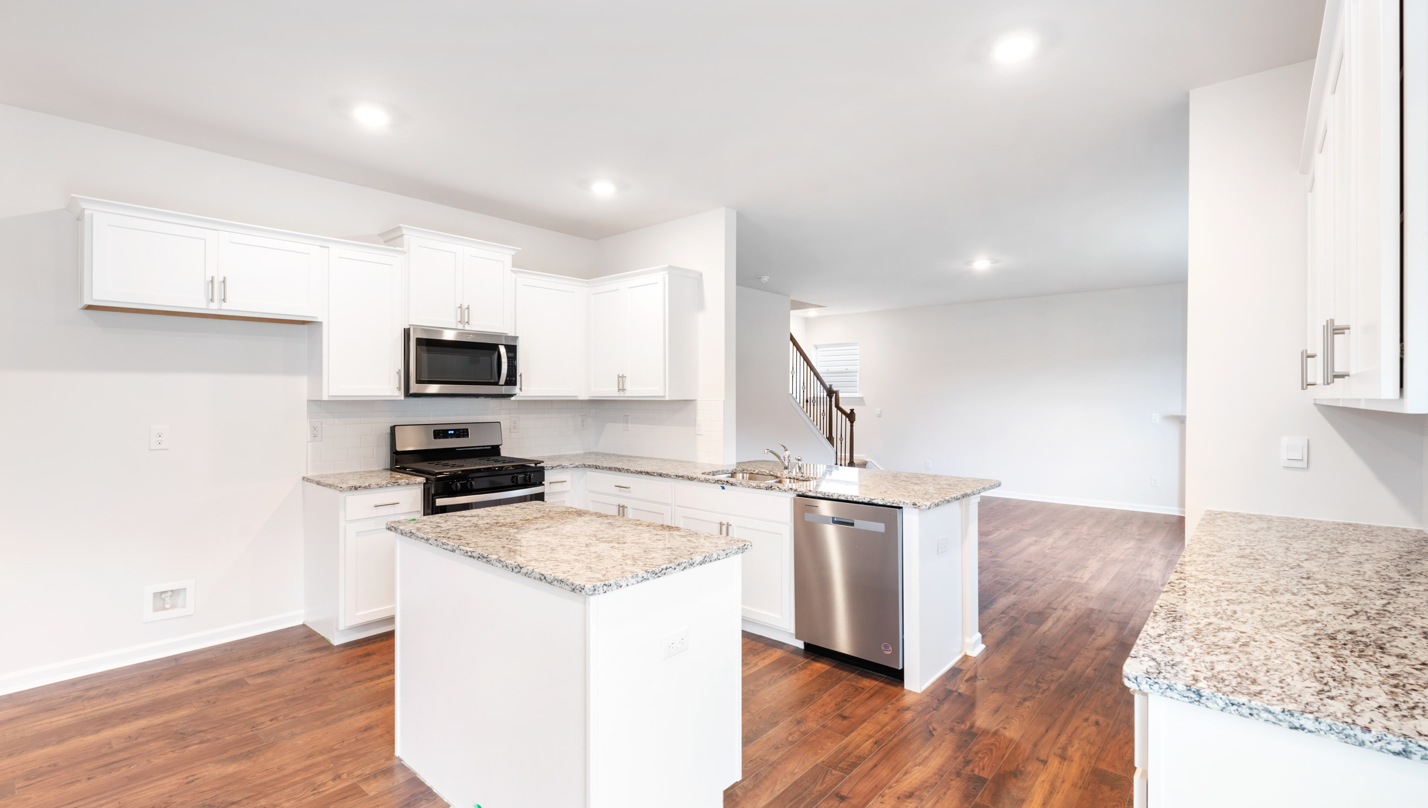 Kitchen with island and granite countertops.