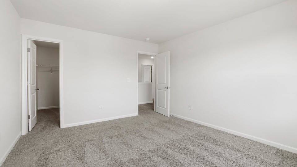 Bedroom with carpet and window.