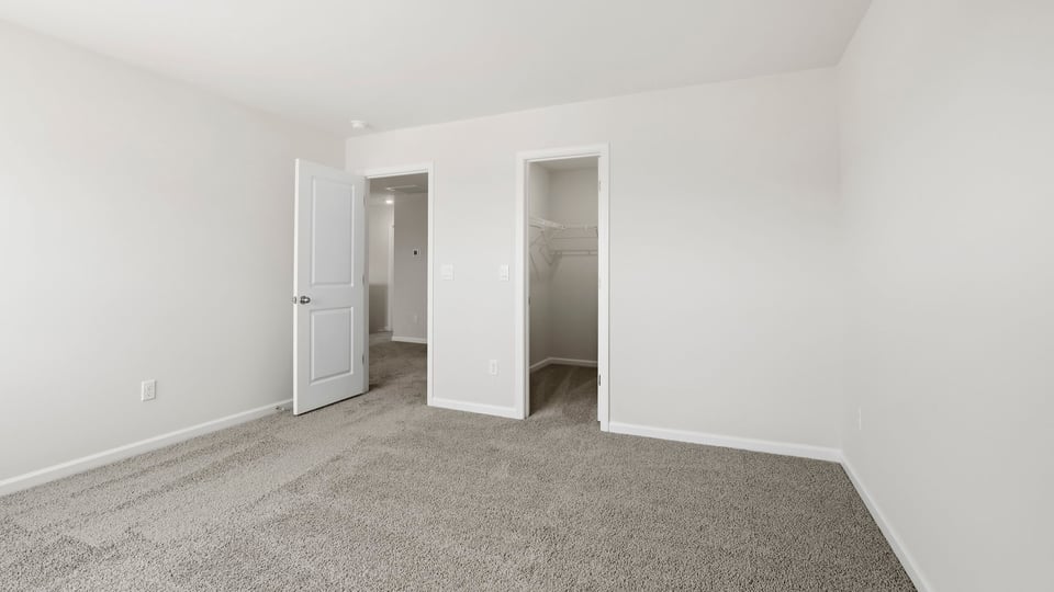 Bedroom with carpet and window.