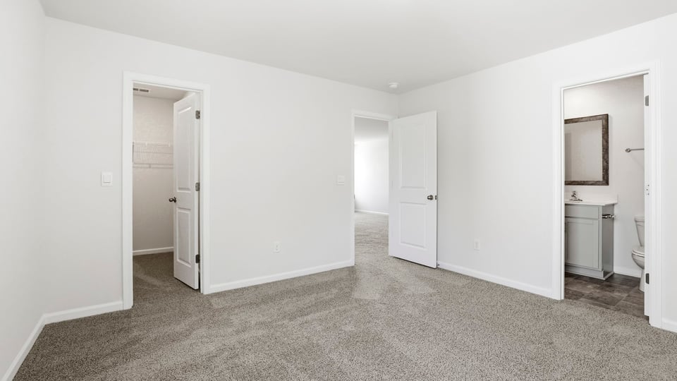 Bedroom with carpet and window.
