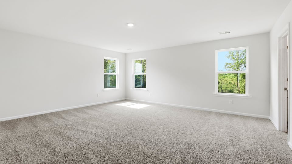 Bedroom with carpet and window.