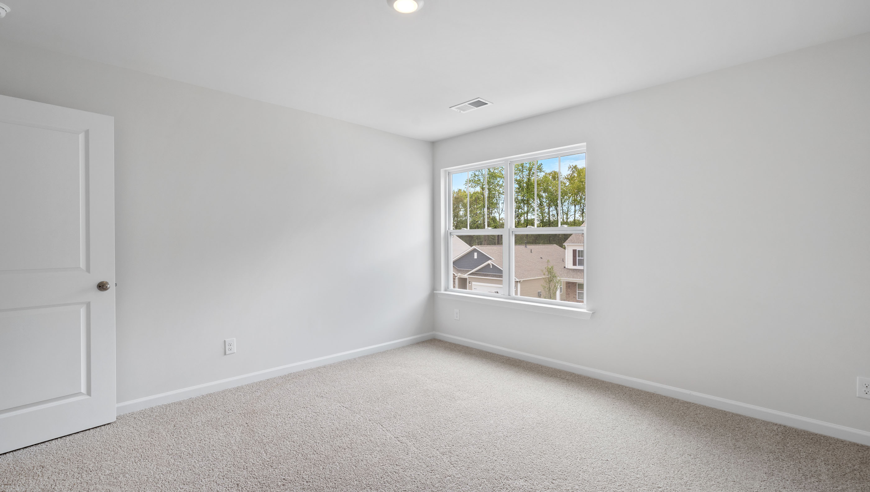 Bedroom with carpet and window.