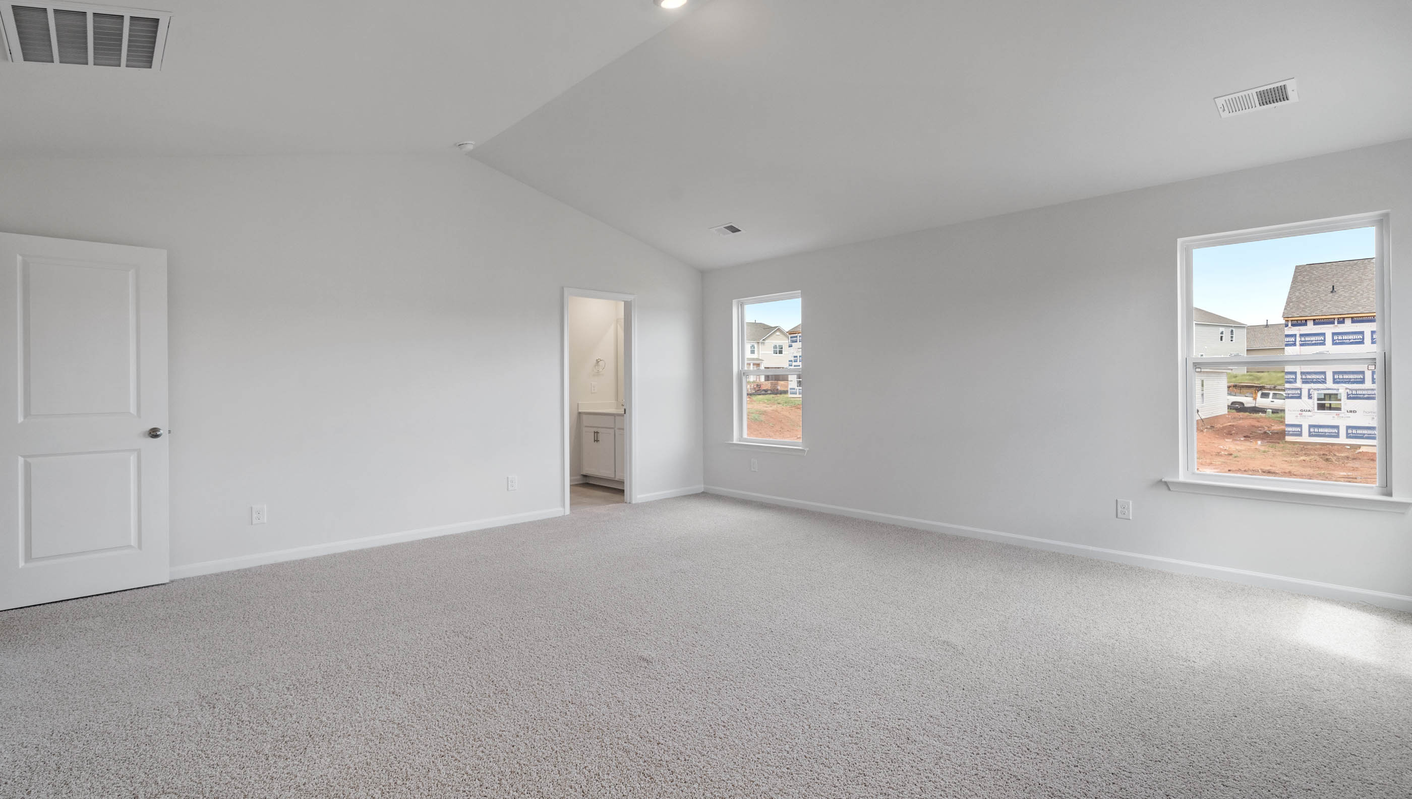 Bedroom with carpet and window.