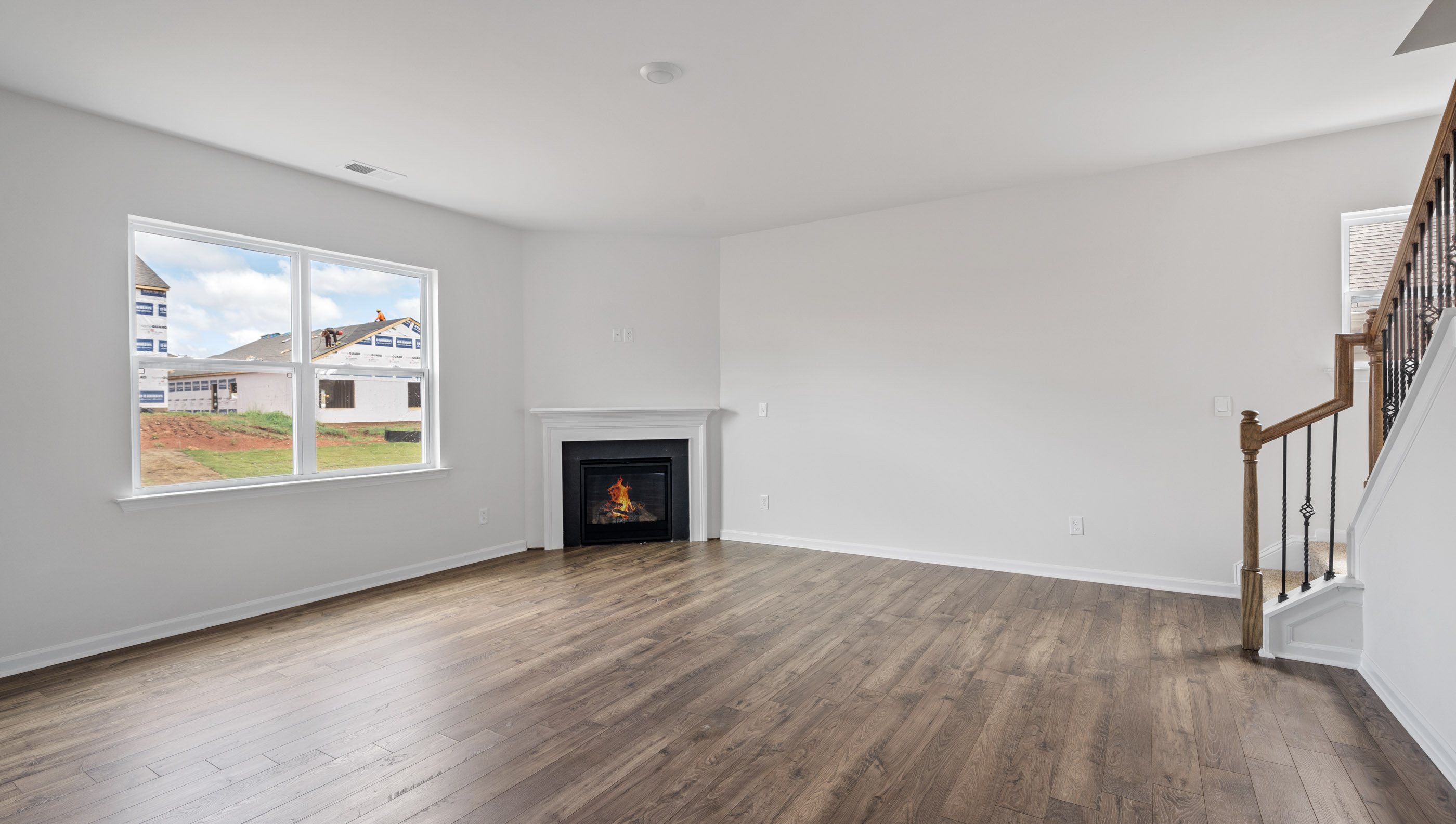 Family room with fireplace and windows.