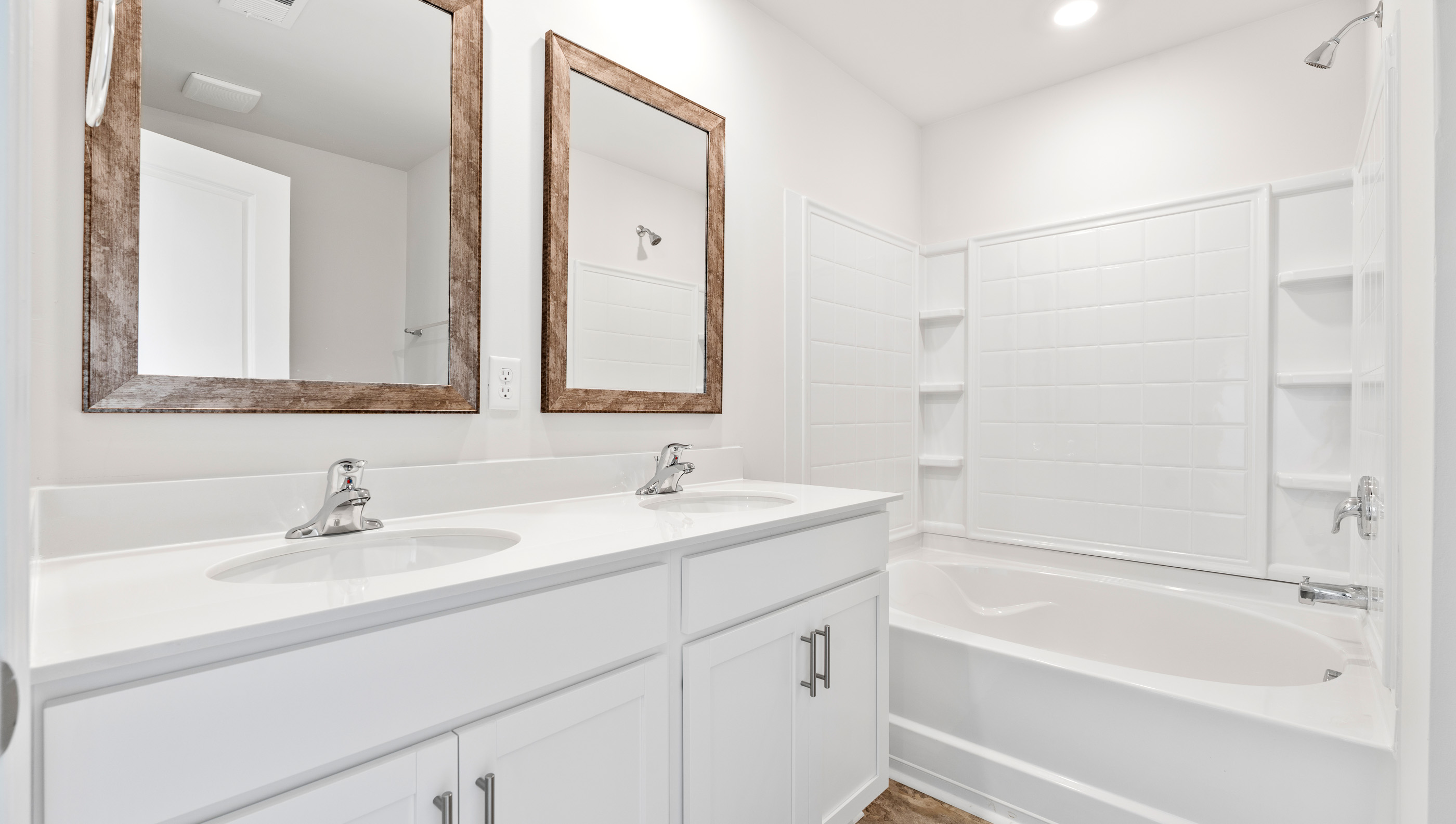 Bathroom with double vanity and tub.