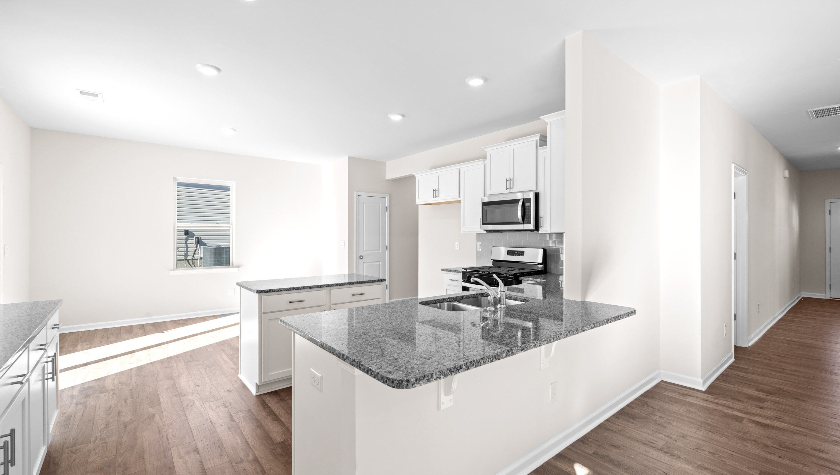 Kitchen and island with granite countertops.