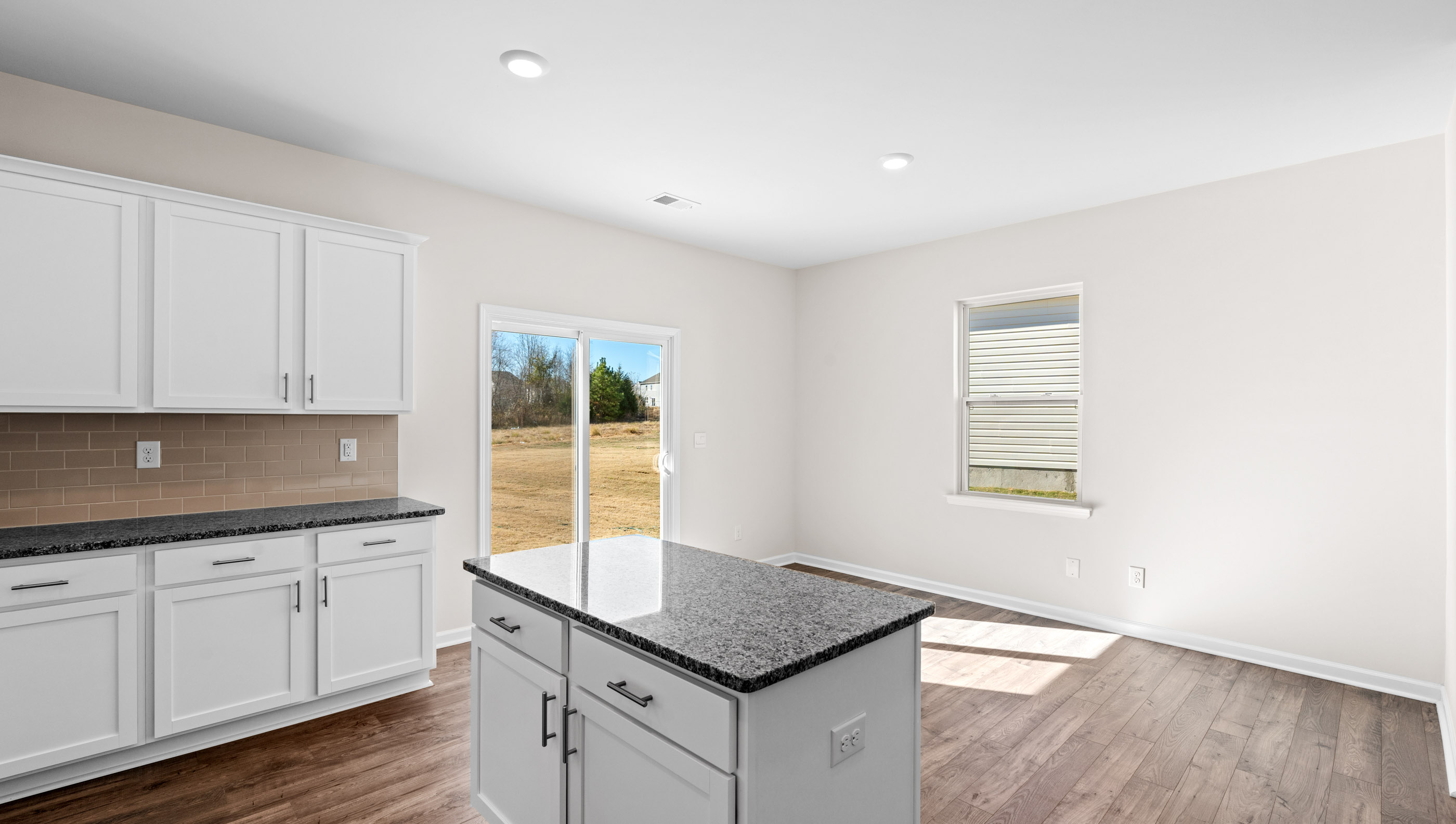 Kitchen and island with granite countertops.