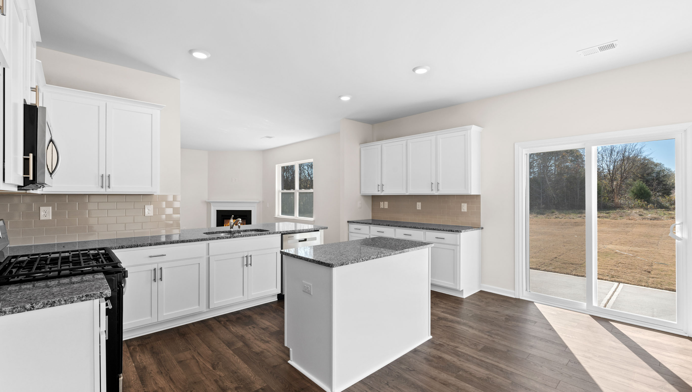 Kitchen and island with granite countertops.