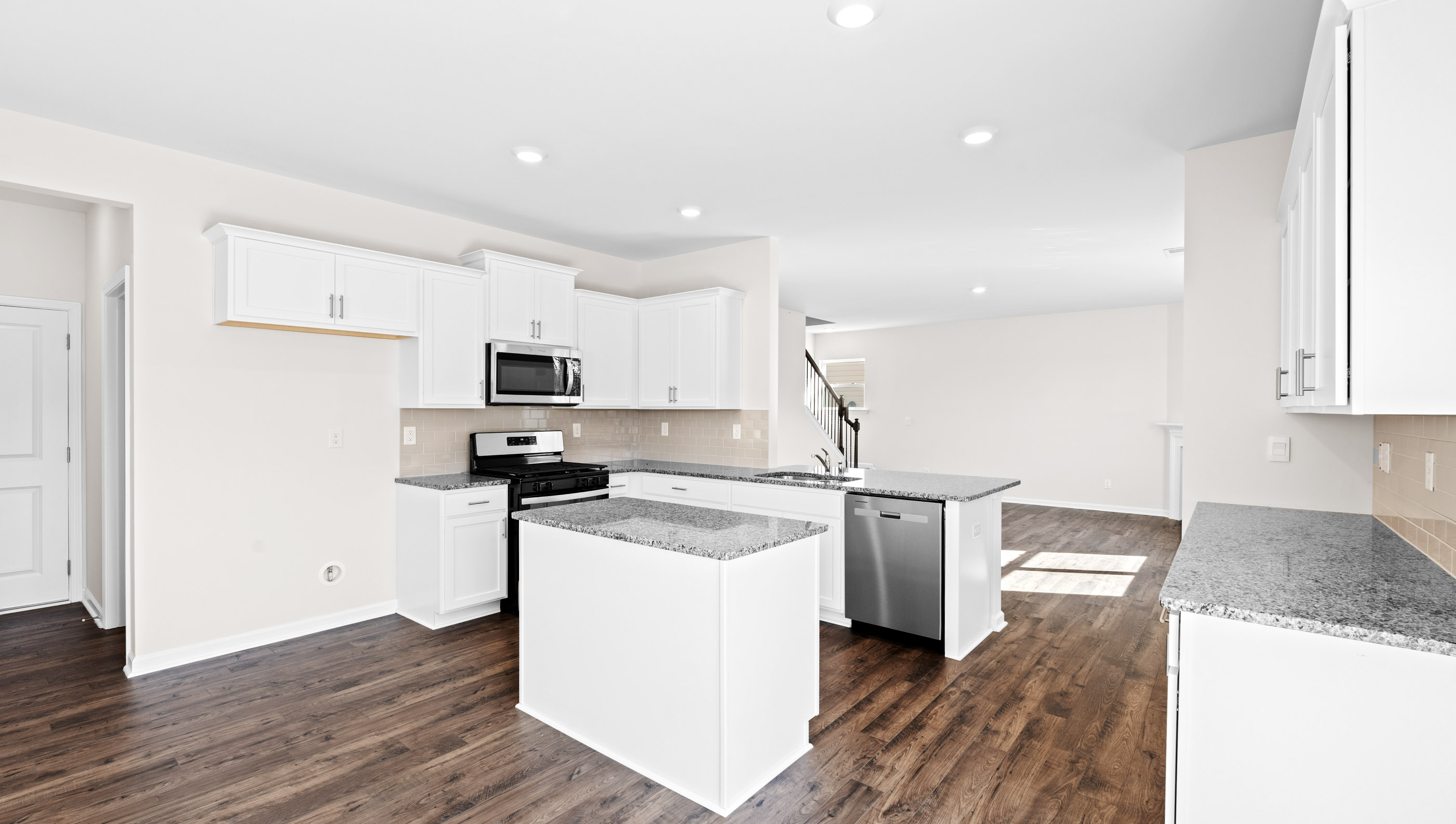 Kitchen and island with granite countertops.