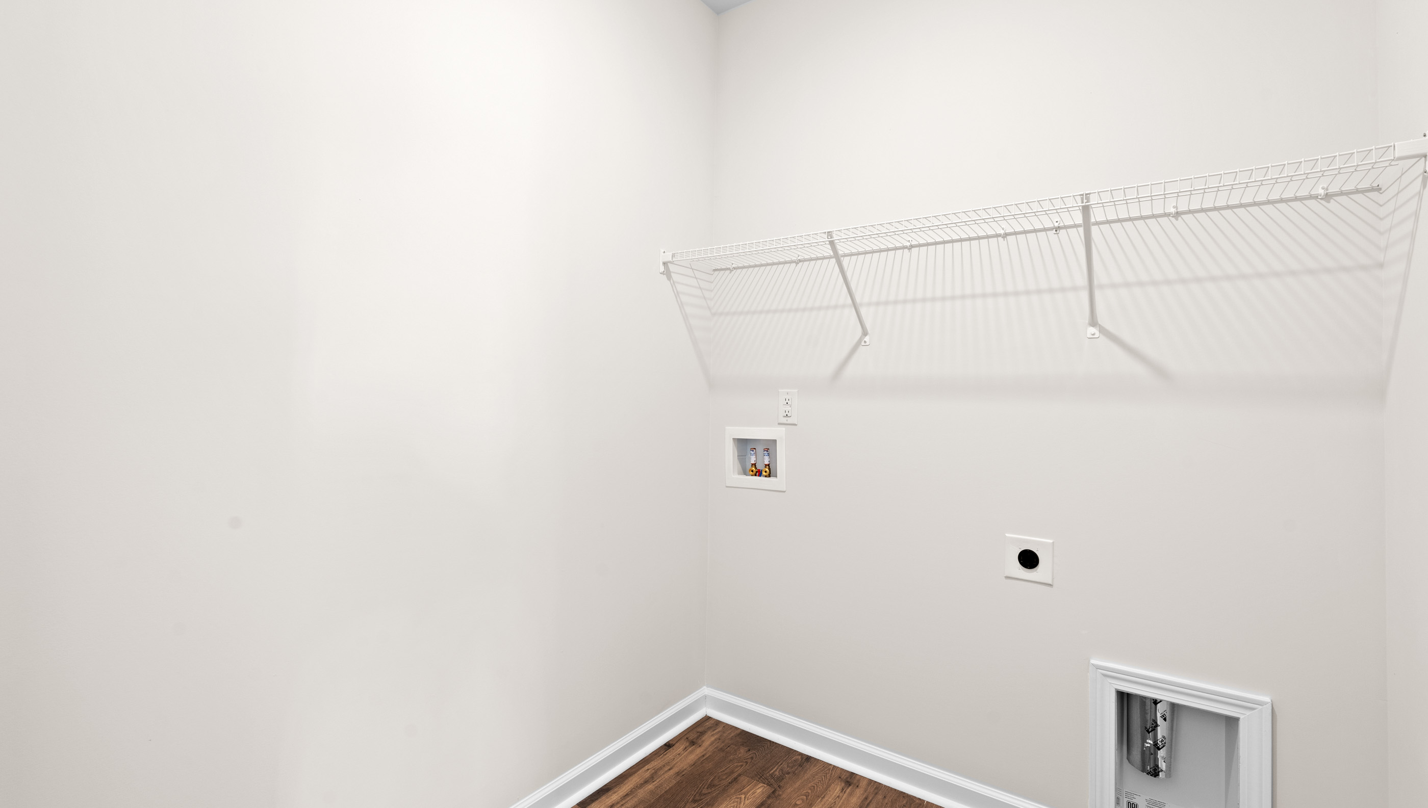 Walk in laundry with shelves.