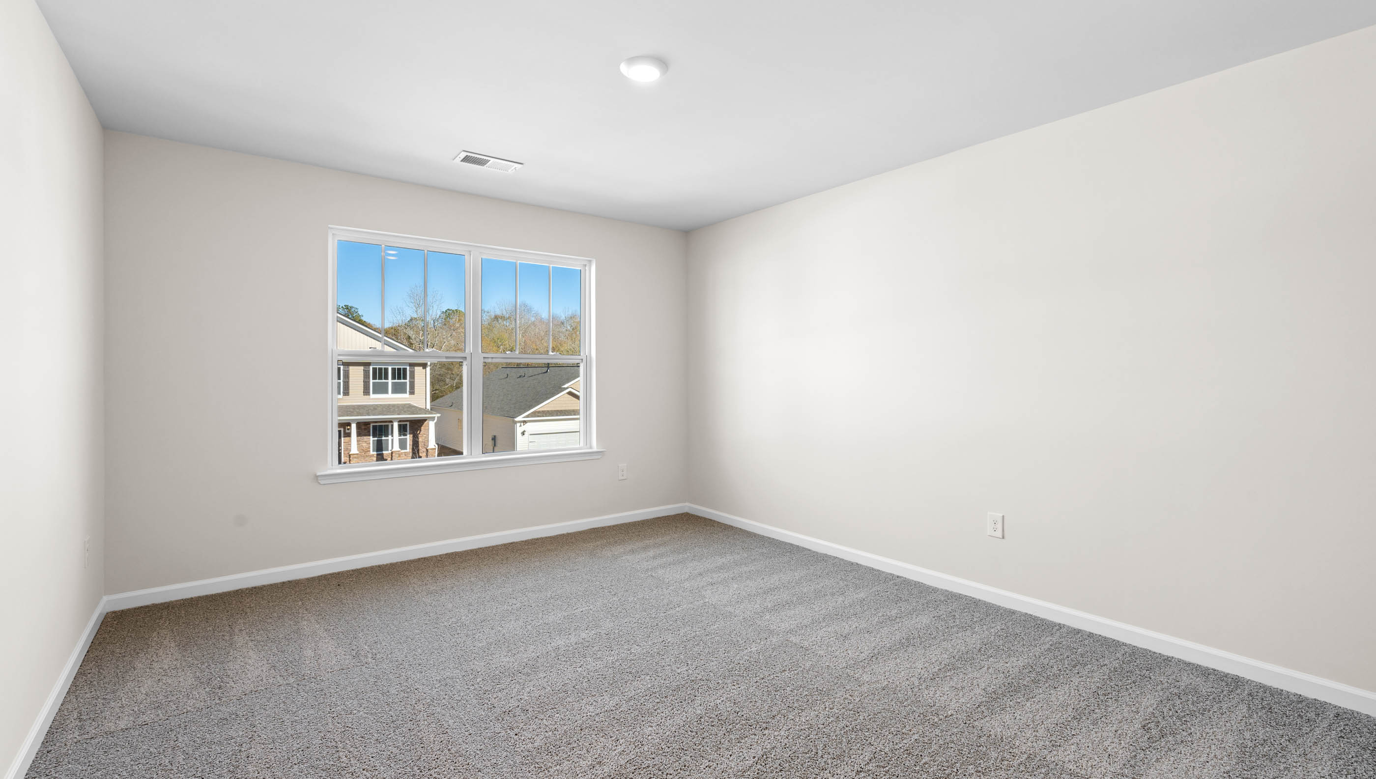 Bedroom with carpet and windows.