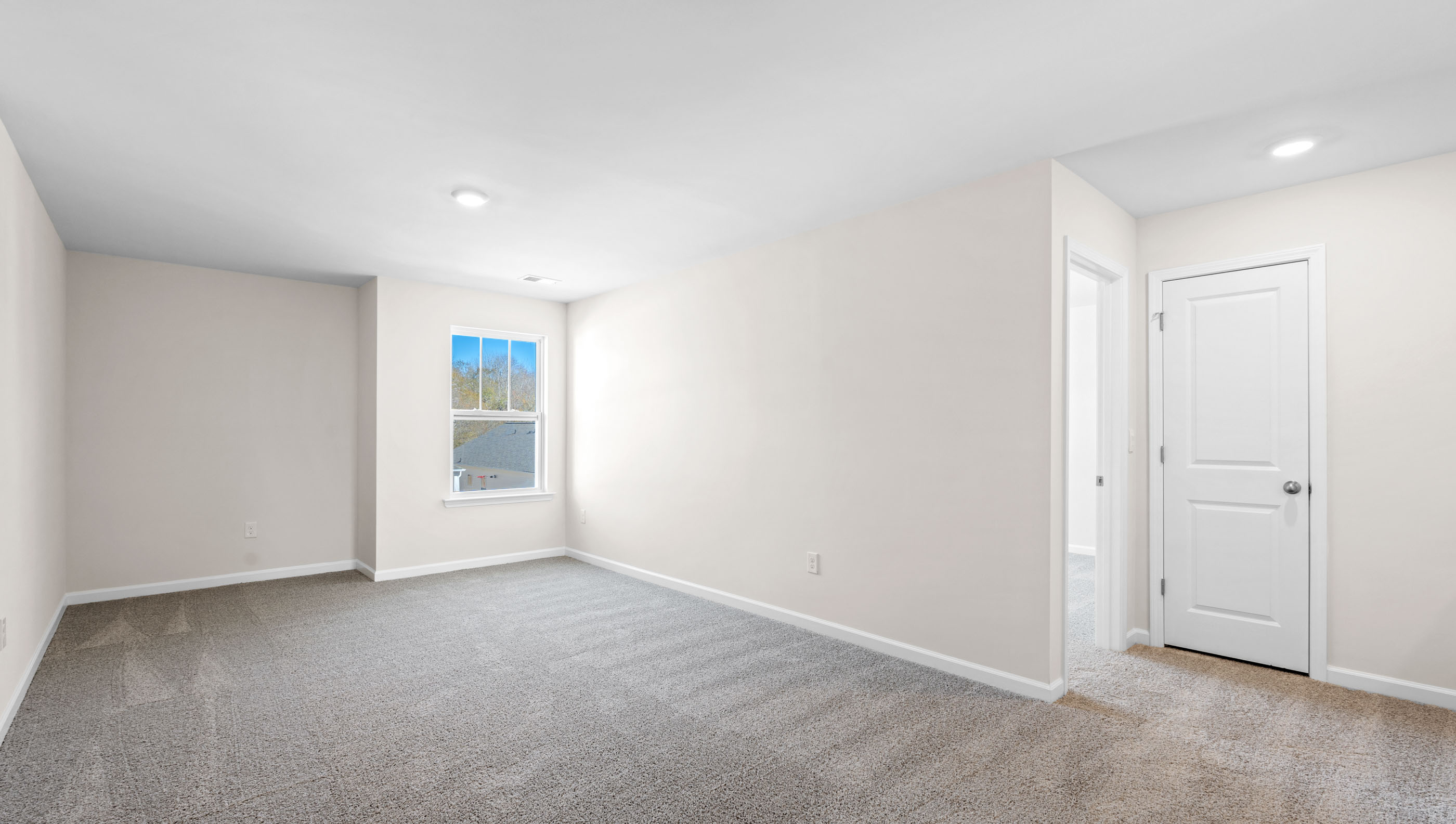 Bedroom with carpet and windows.