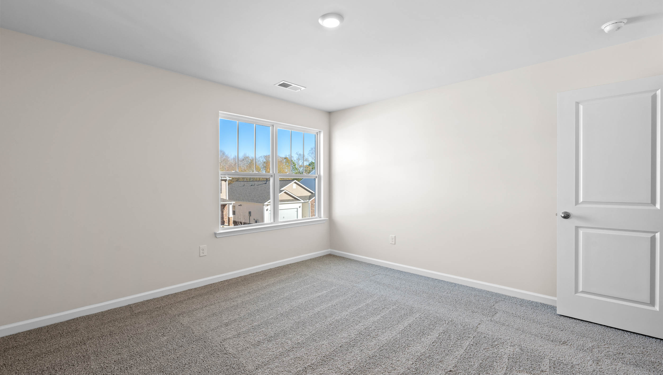 Loft area with carpet and windows.