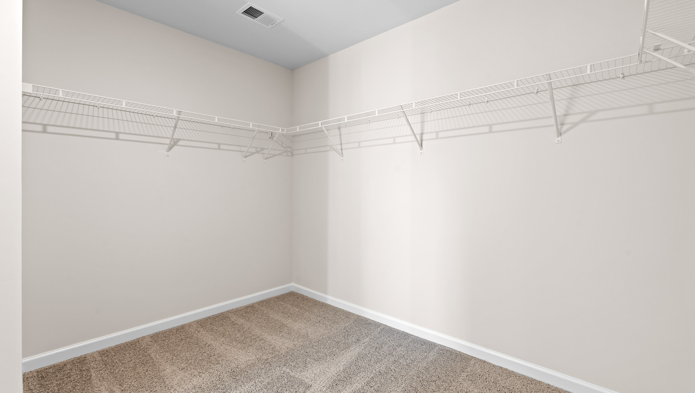 Walk in closet with shelves.