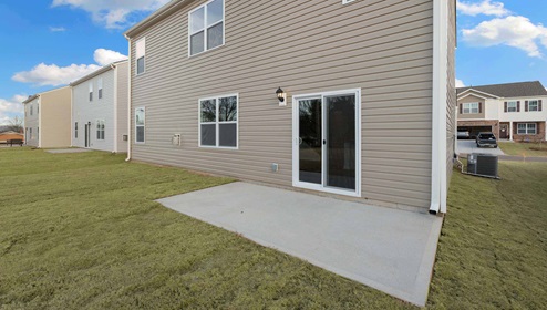 Back exterior of home with patio area.