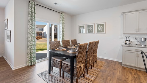 Dining room area with view of kitchen.