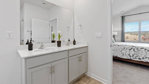 Double sink vanity and tub.
