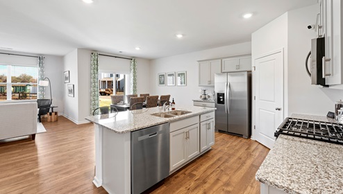 Kitchen and island with granite counter tops.
