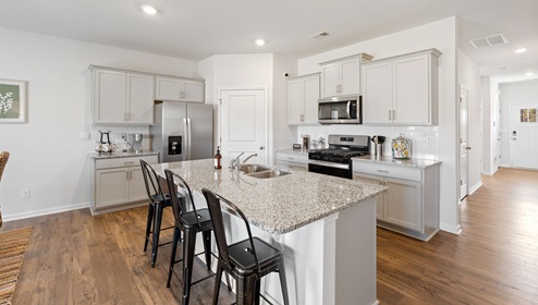 Kitchen and island with granite counter tops.