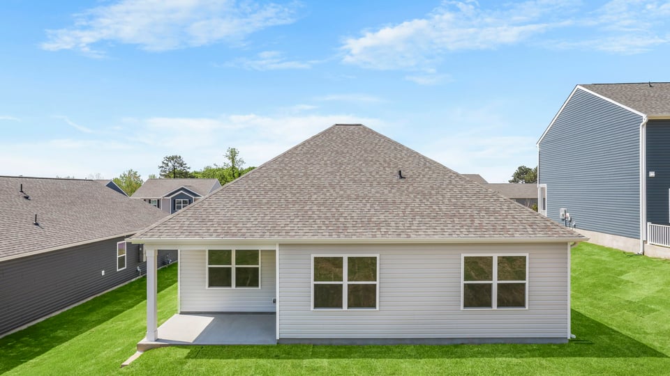 Back exterior of home with large backyard.