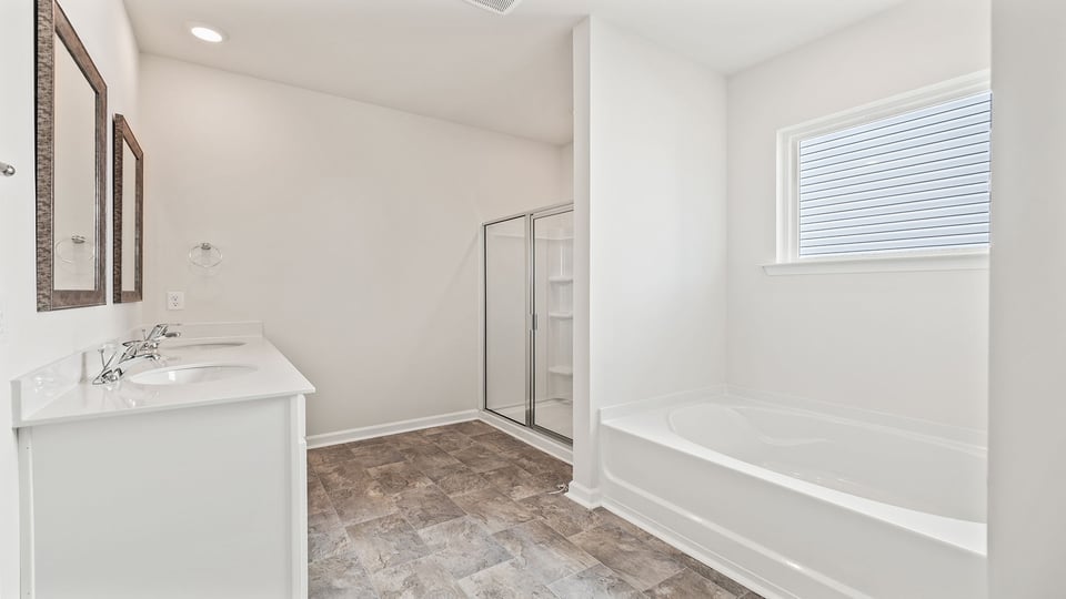 Bathroom with vanity, tub and walk in shower.