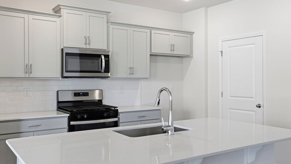Kitchen with island and countertops.