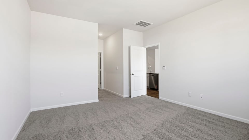 Bedroom with carpet and window.