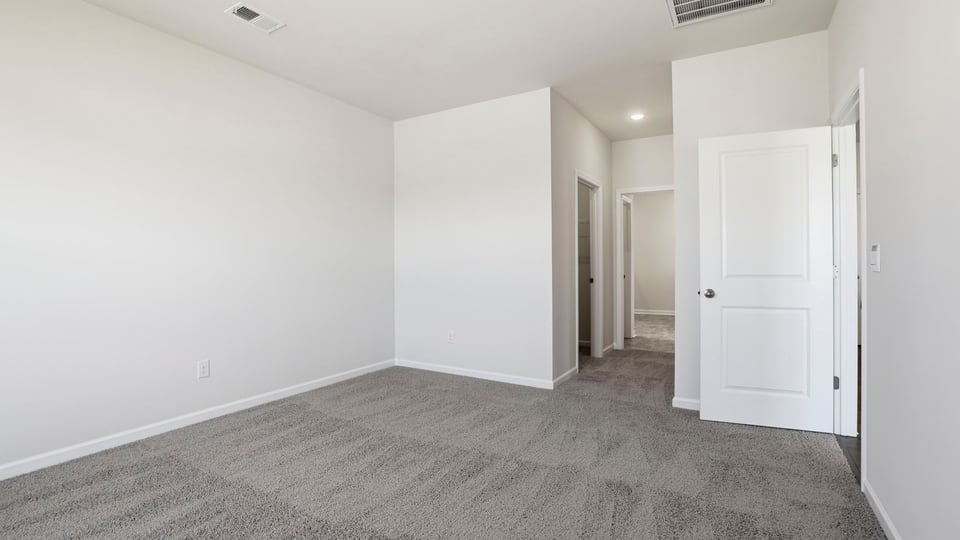 Bedroom with carpet and window.