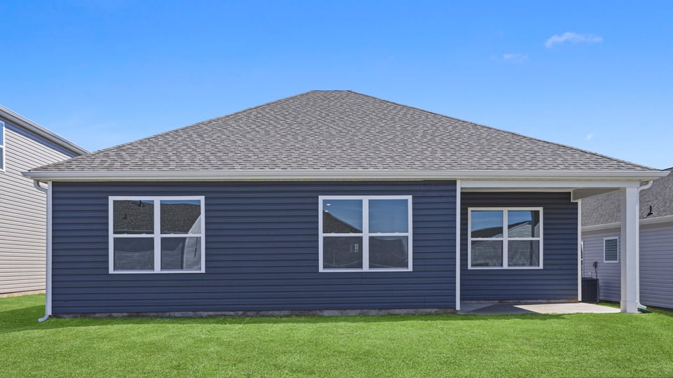 Exterior of home with large backyard.