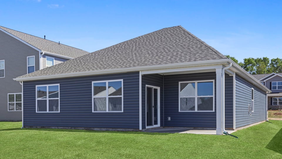 Exterior of home with large backyard.