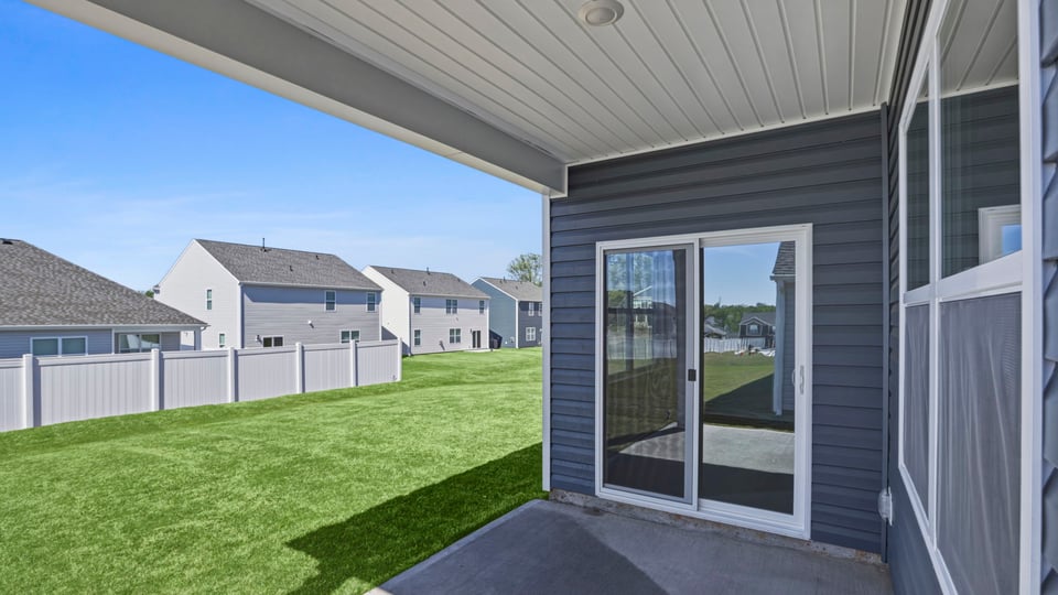 Exterior of home with large backyard.