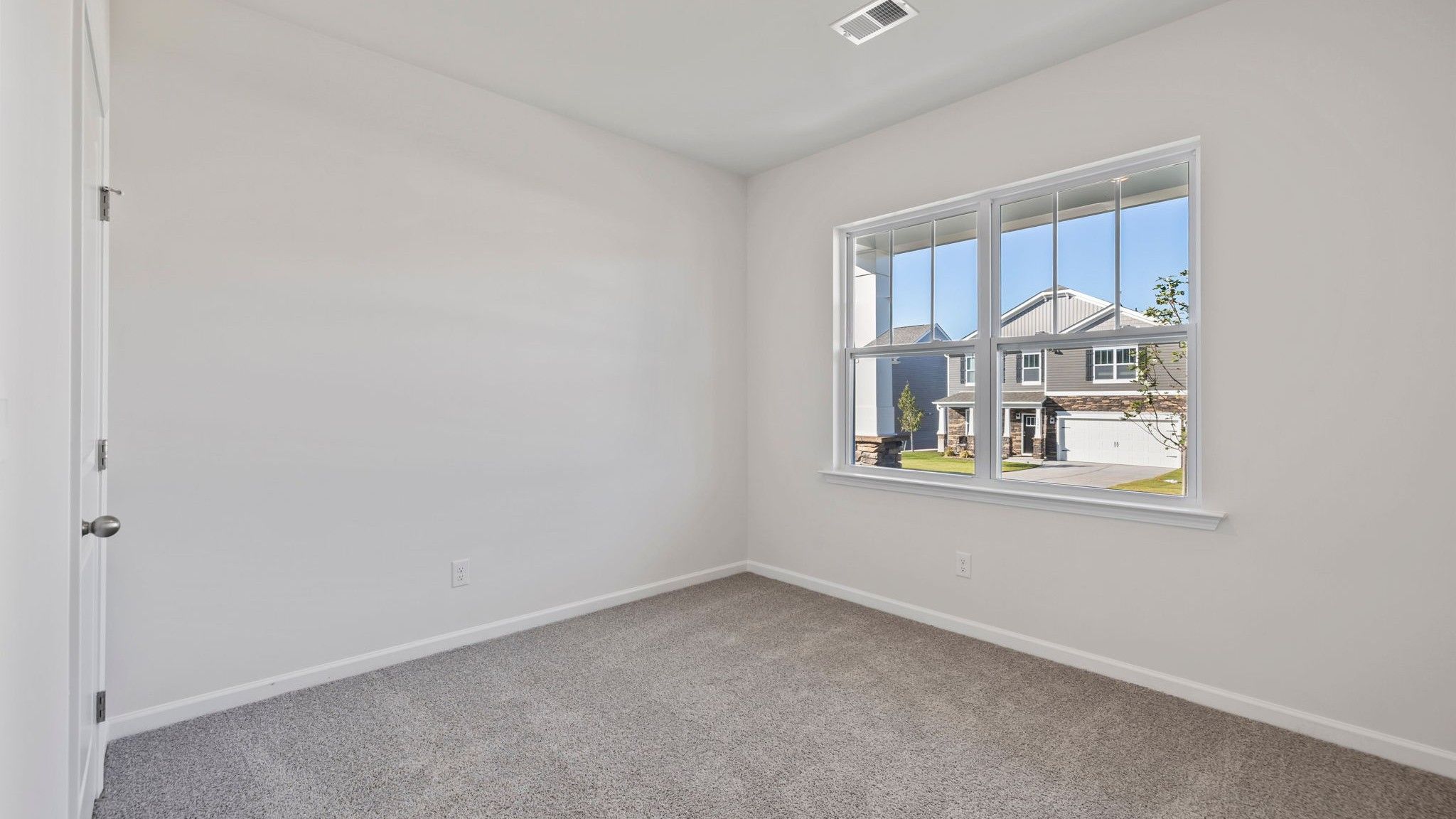 Bedroom with carpet and window.