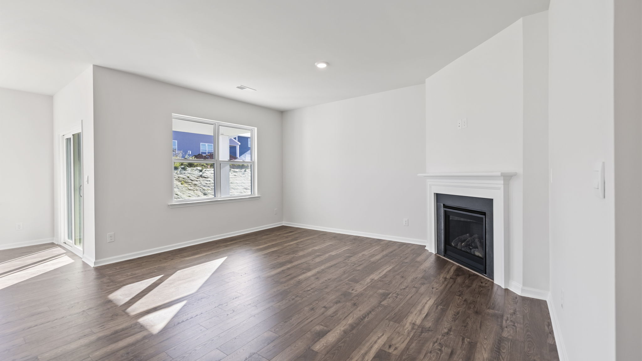 Livingroom with windows and fireplace.