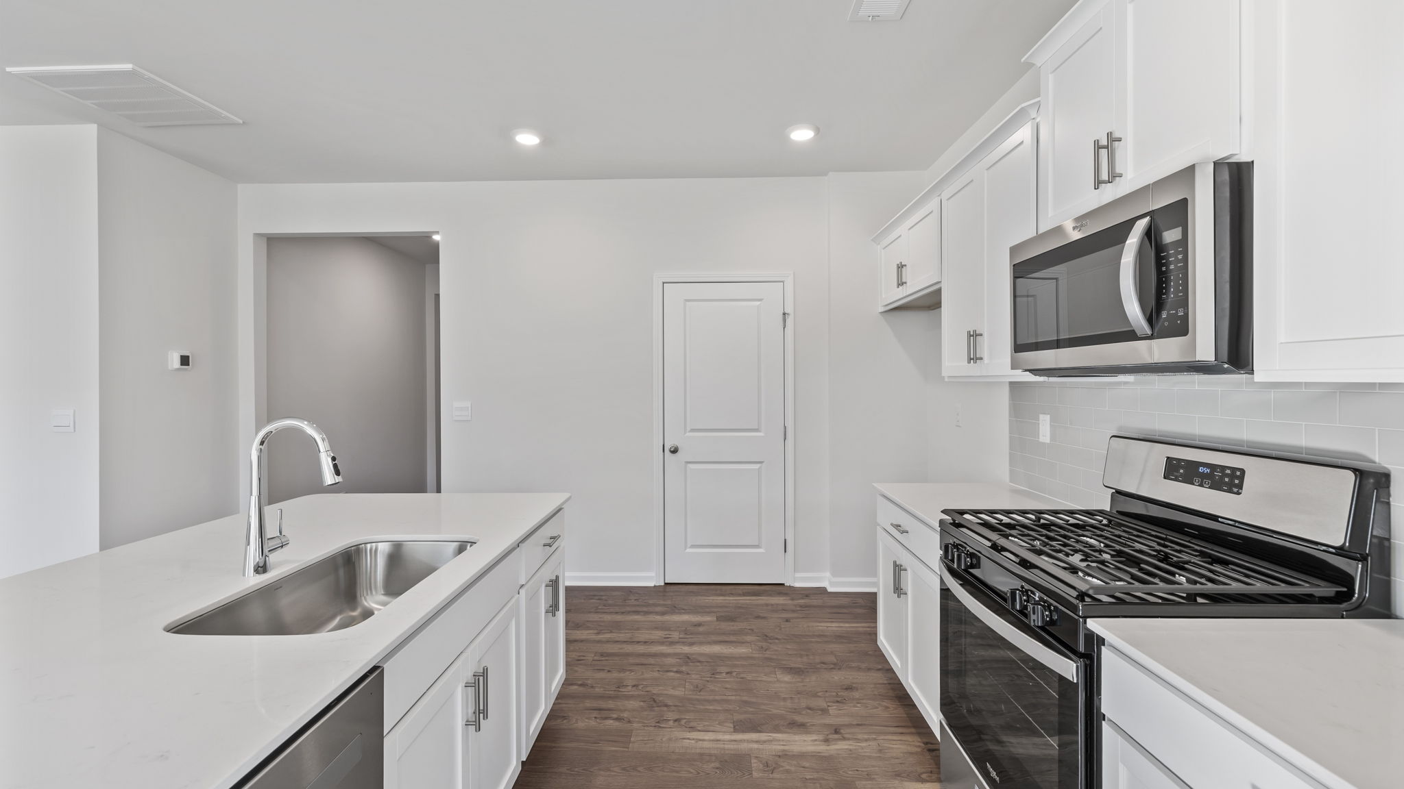 Kitchen and island with granite counter tops.