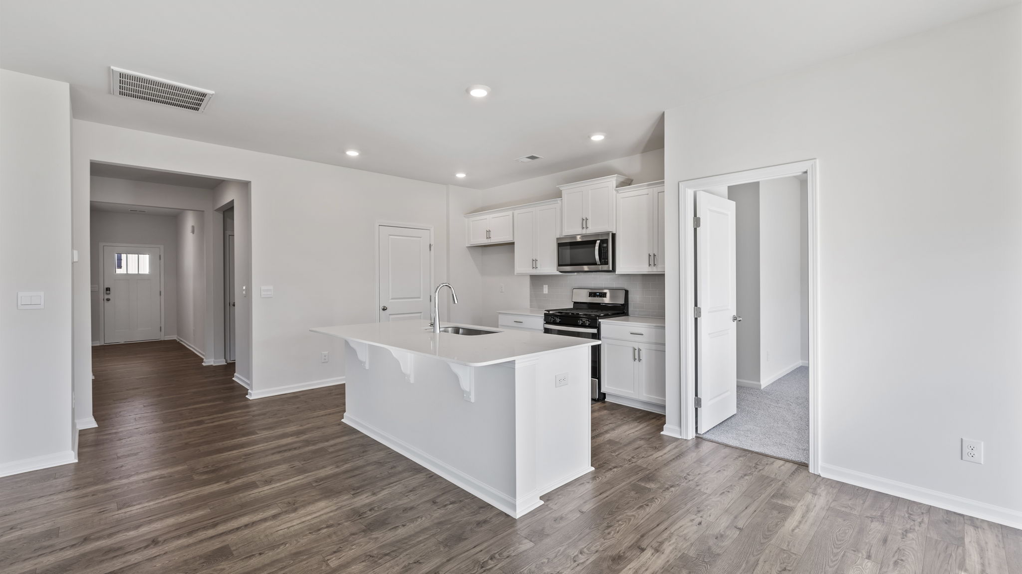 Kitchen and island with granite counter tops.