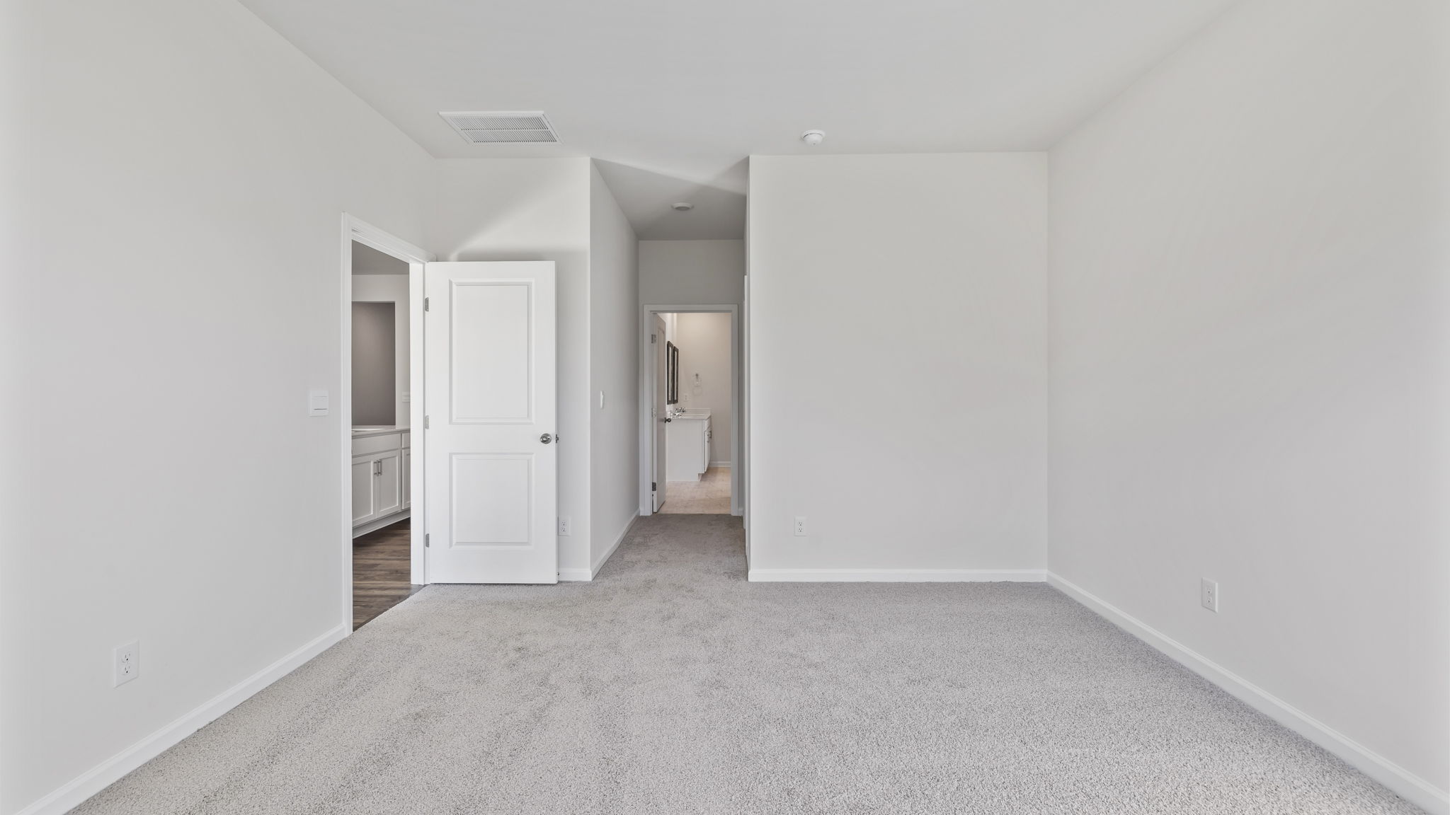 Primary bedroom with carpet.