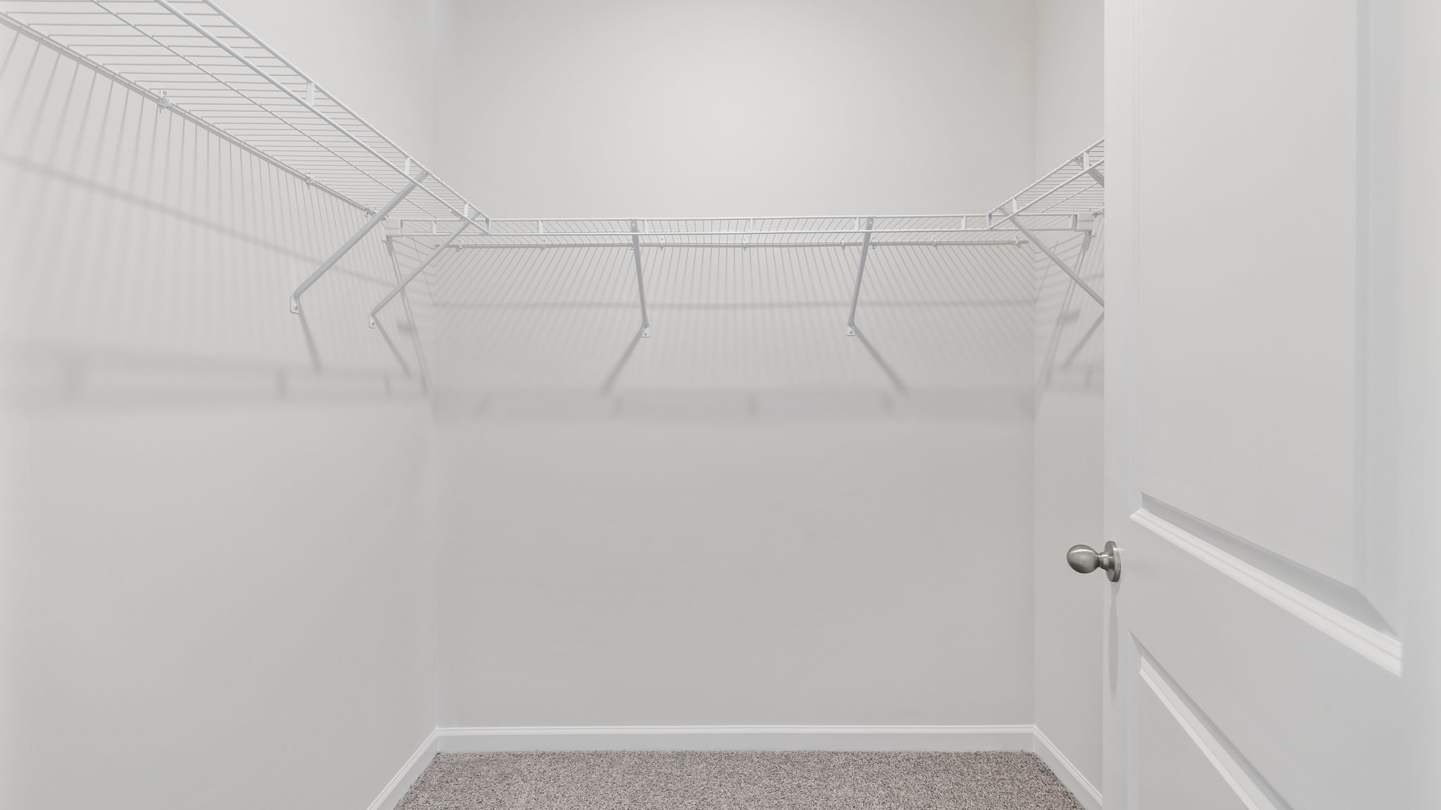 Walk in closet with shelves.