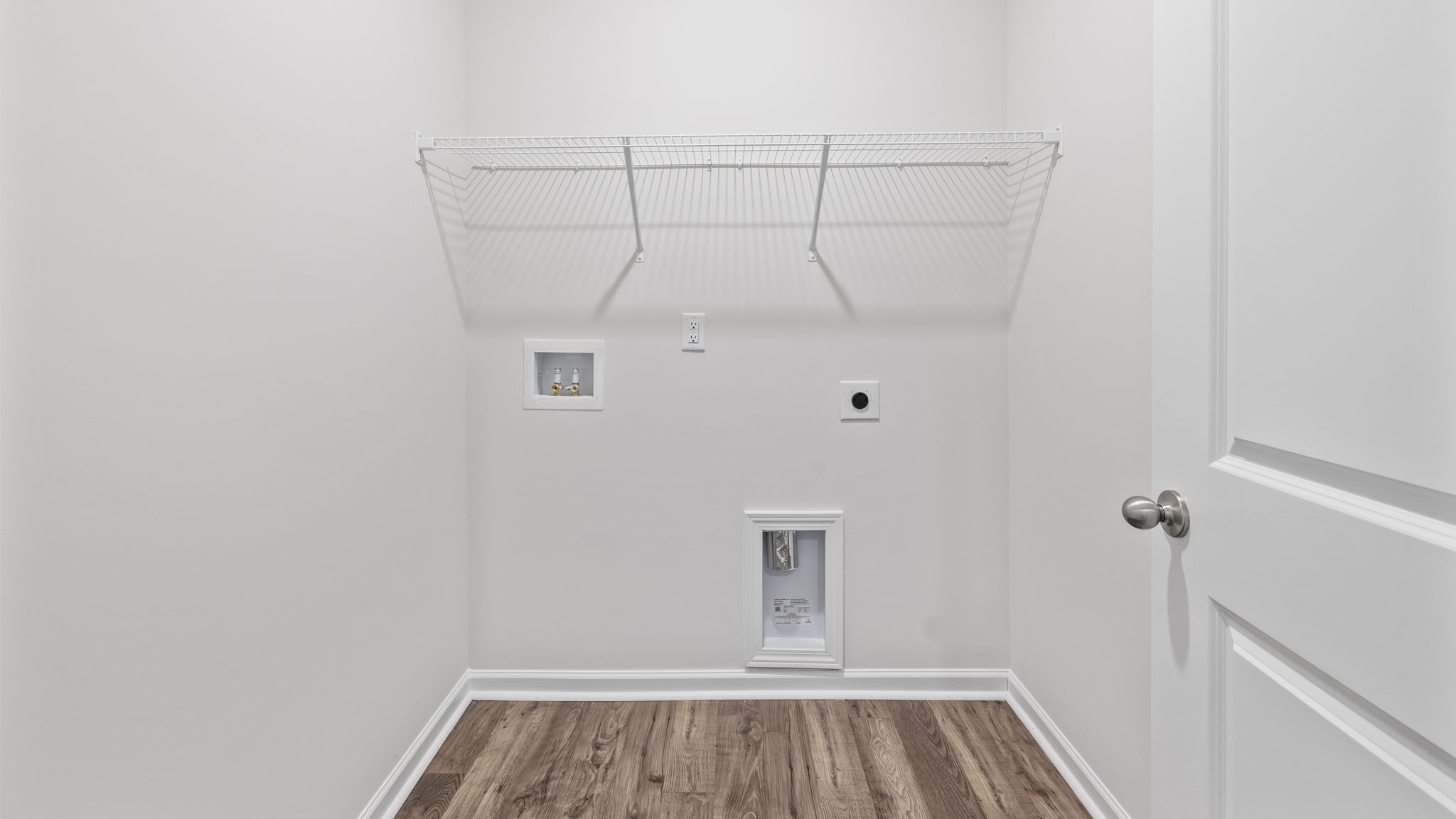 Walk in laundry with shelves.