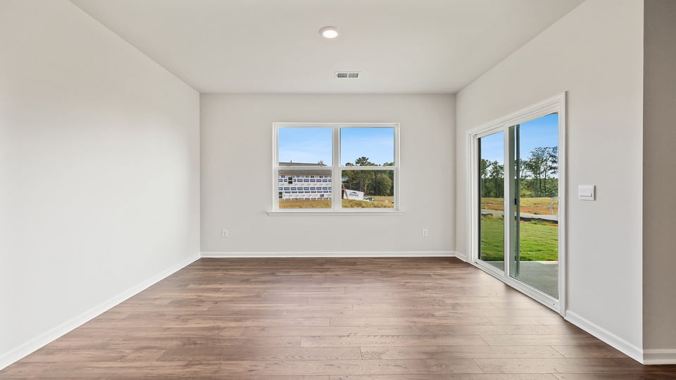 Dining room with windows and sliding doors.