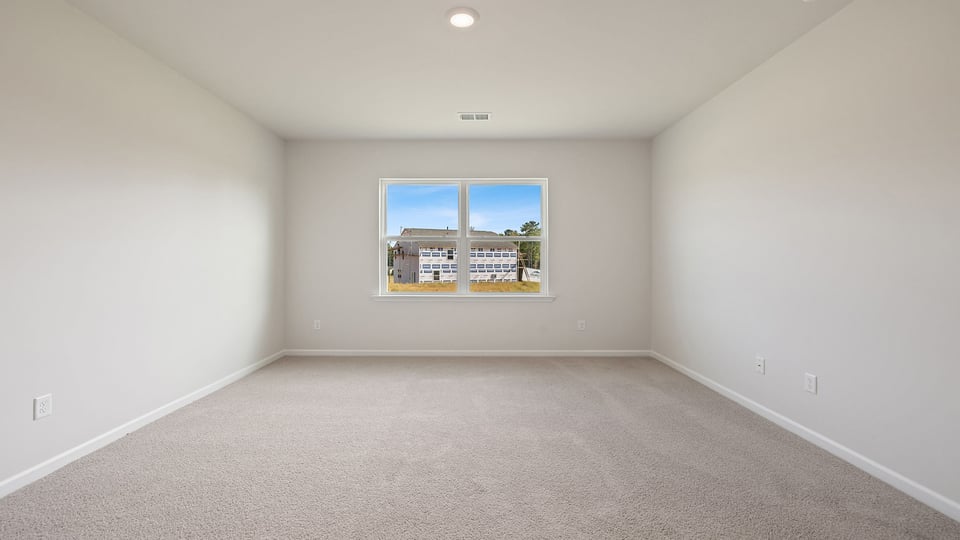 Bedroom with carpet and window.