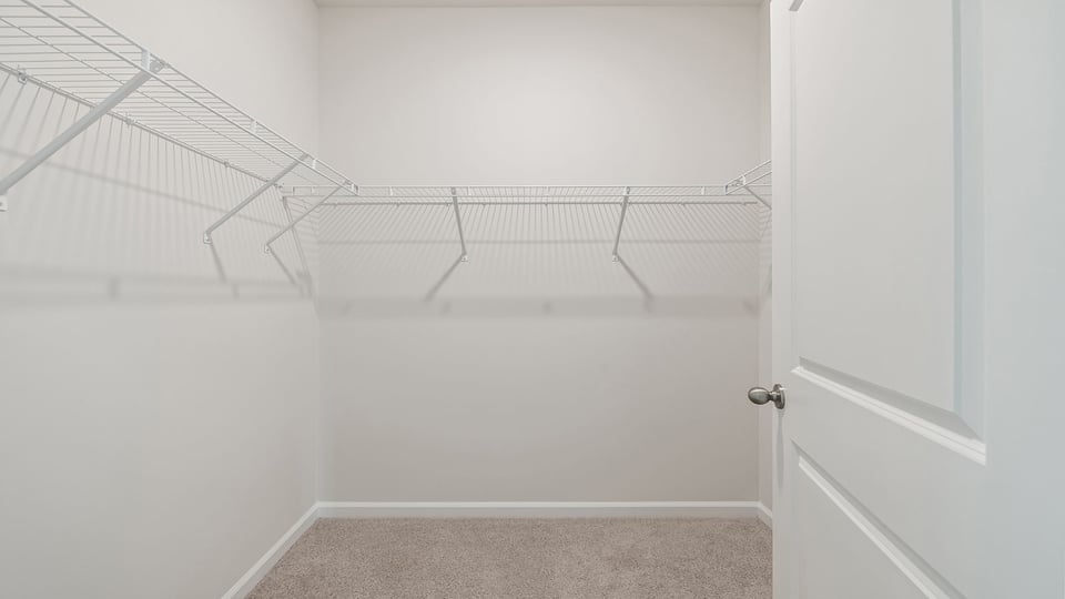 Walk in closet with shelves.