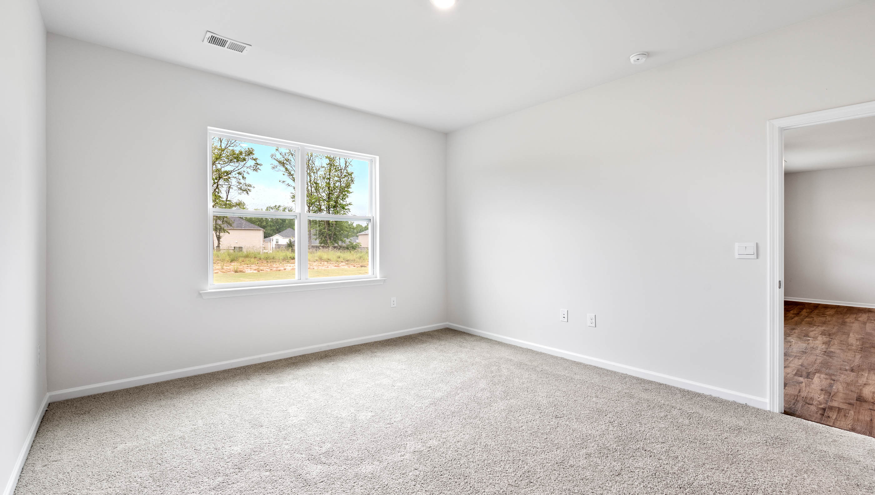 Bedroom with carpet and window.
