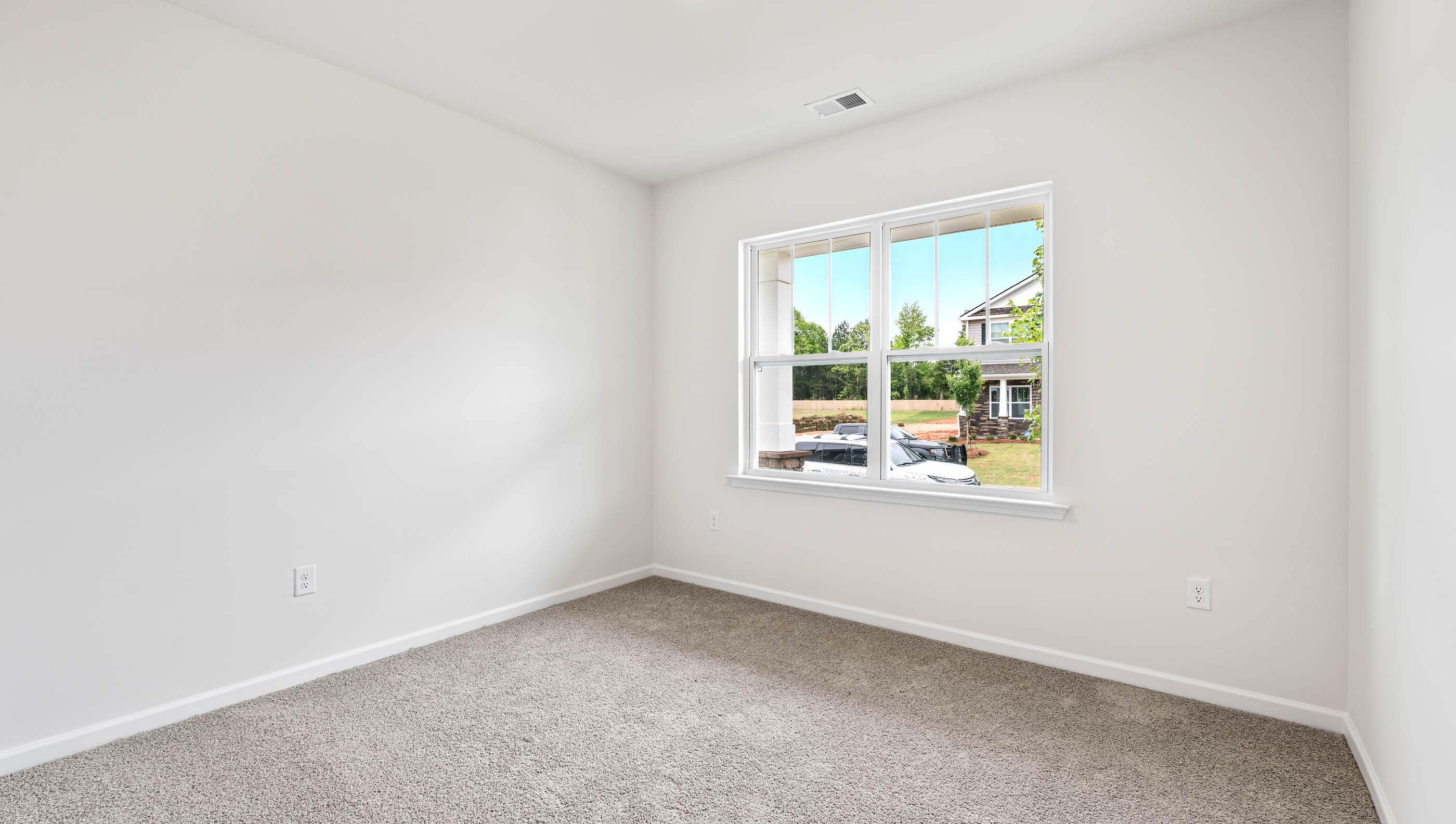 Bedroom with carpet and window.