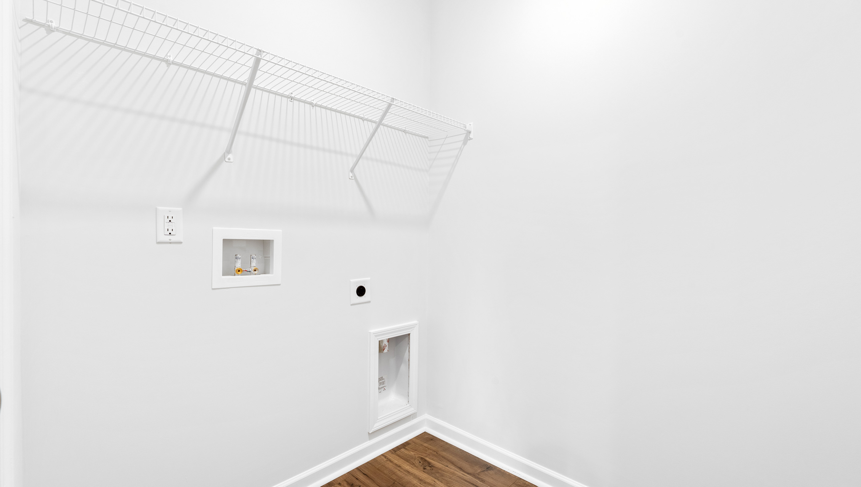 Walk in laundry with shelves.